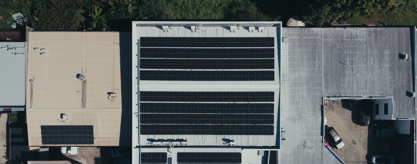 Aerial view of a commercial rooftop solar array on a wholesale foods warehouse, video preview